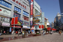 Nanjing Road walking street. Commercial shopping street with building facades covered with a mass of advertising signs