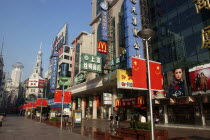 Nanjing Road walking street. Commercial shopping street with building facades covered with a mass of advertising signs