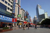 Nanjing Road walking street. Commercial shopping street with building facades covered with a mass of advertising signs