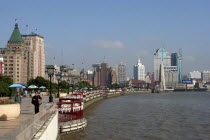 The Bund aka Zhong Shan Road. View along the promenade that runs along the Huangpu River with the city skyline in the distance