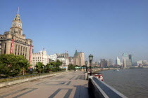 The Bund aka Zhong Shan Road. View along the promenade that runs along the Huangpu River with the city skyline in the distance