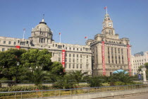 The Bund aka Zhong Shan Road. View of the 1930s style waterfront architecture with clock tower and domed building