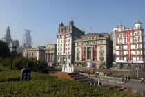 The Bund aka Zhong Shan Road. View along the 1930s style waterfront architecture with fountain in the foreground