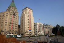 The Bund aka Zhong Shan Road. 1930s style waterfront architecture including the Peace Hotel and the Bank of China with statue of Mao and fountain in the foreground