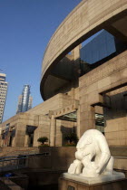Modern exterior of the Art Museum with white statue in surrounding pool