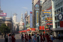 Nanjing Road walking street. Commercial shopping street with group of people exercising outside
