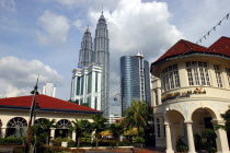 View from city street toward the Petronas Towers and other tall architecture