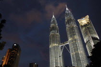 Angled view looking up at the Petronas Twin Towers illuminated at night