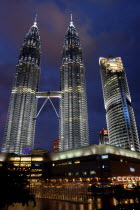 Angled view looking up at the Petronas Twin Towers illuminated at night