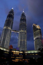 Angled view looking up at the Petronas Twin Towers illuminated at night