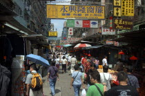 Streetscene with shoppers and advertising banners overhead
