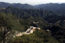 View over a section of the wall which leads through the green hilly landscape