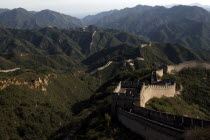 View over a section of the wall which leads through the green hilly landscape