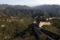 View over a section of the wall which leads through the green hilly landscape