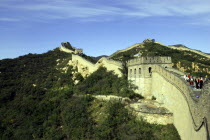 View alongside a section of the wall which runs through the hilly green landscape