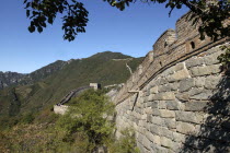 View alongside a section of the wall which runs through the hilly green landscape