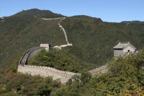 View over a section of the wall which leads through the green hilly landscape