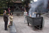 Lama Temple. People lighting incense during worship in the Temple courtyard
