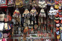 Market stall displaying selection of bells bags and chimes with assortment of ornaments