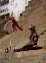 Sadhu meditating in the early morning sun on the ghats of the River Ganges