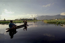 Nagin Lake. Two men in a canoe rowing with a single oar