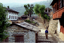 View of the village with woman walking down a cobbled street