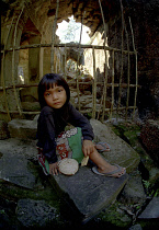 Girl sitting at Banteay Srei or The Citadel of the Women where children act as guides to earn money for schooling