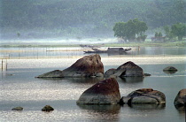 View over the rocky lagoon with passing boat
