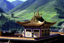 Golden roofed Labrang Monastery and green hillsides beyond