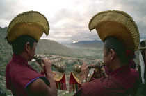 Two monks blowing spiritual horns