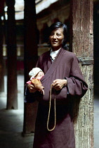 Portrait of father with small child tucked in his clothing outside the Jokhang Temple