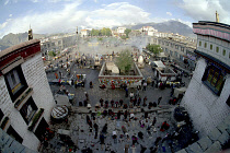 Wide angle view from the rooftop of the Jokhang Temple over people lying prostrate in front