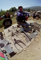 Wide angle view of market stall vendor and display of tools