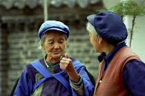 Two elderly women talking in the street