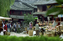 Street scene with various market stalls selling household goods