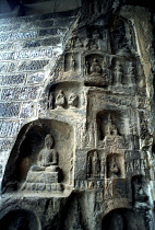 Ancient Longmen caves. Images of Buddha and his disciples carved in to the cliff wall