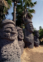 Tolharubang grandfather stones carved from lava rock which are guardians of the gates to Chejus ancient towns