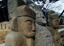 Carved Guardian Stones standing in a row at the Buddhist Temple