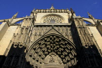 Angled view looking up at the Puerta de la Asuncion gothic style portal of the Cathedral
