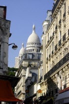 Sacre Coeur domes seen from a side street