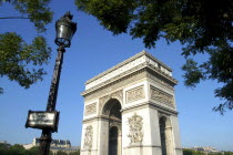 View of the Arc de Triomphe with lampost and sign in the foreground