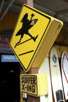 Surf shop sign with silhouette of surfer holding board
