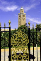 View through black and gold wrought iron gate towards the minaret of Koutoubia Mosque
