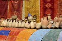 Display of colourful cloths and ceramics for sale