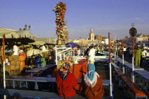 Djemaa El Fna. Food stall with two customers seated in the foreground