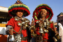 Djemaa El Fna. Two water sellers wearing brightly coloured hats