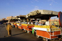 Djemaa El Fna. Row of Orange sellers lined up along the market