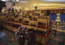 Wat Chayamangkalaram.  Interior with thirty-two metre long reclining Buddha lying behind display of various smaller figures and statues. Also known as Wat Buppharam.