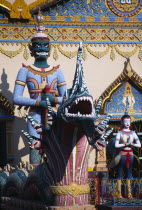 Wat Chayamangkalaram.  Temple guardsman and dragon statues.