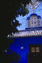 Cheong Fatt Tze Mansion.  Restored Chinese merchants house.  Exterior detail with blue painted walls  wooden window shutters and overhanging roof.